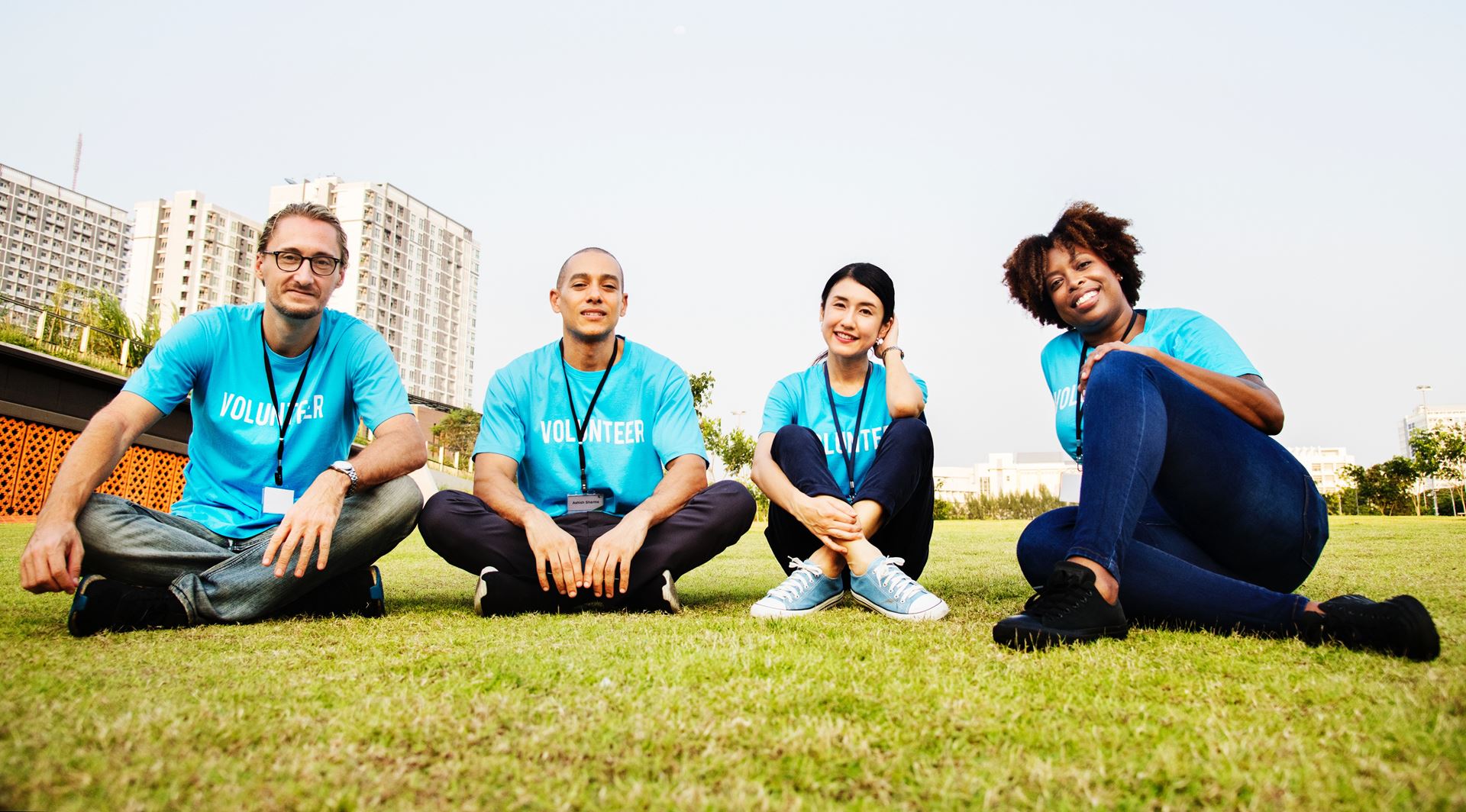 a group of people sitting in a grassy field