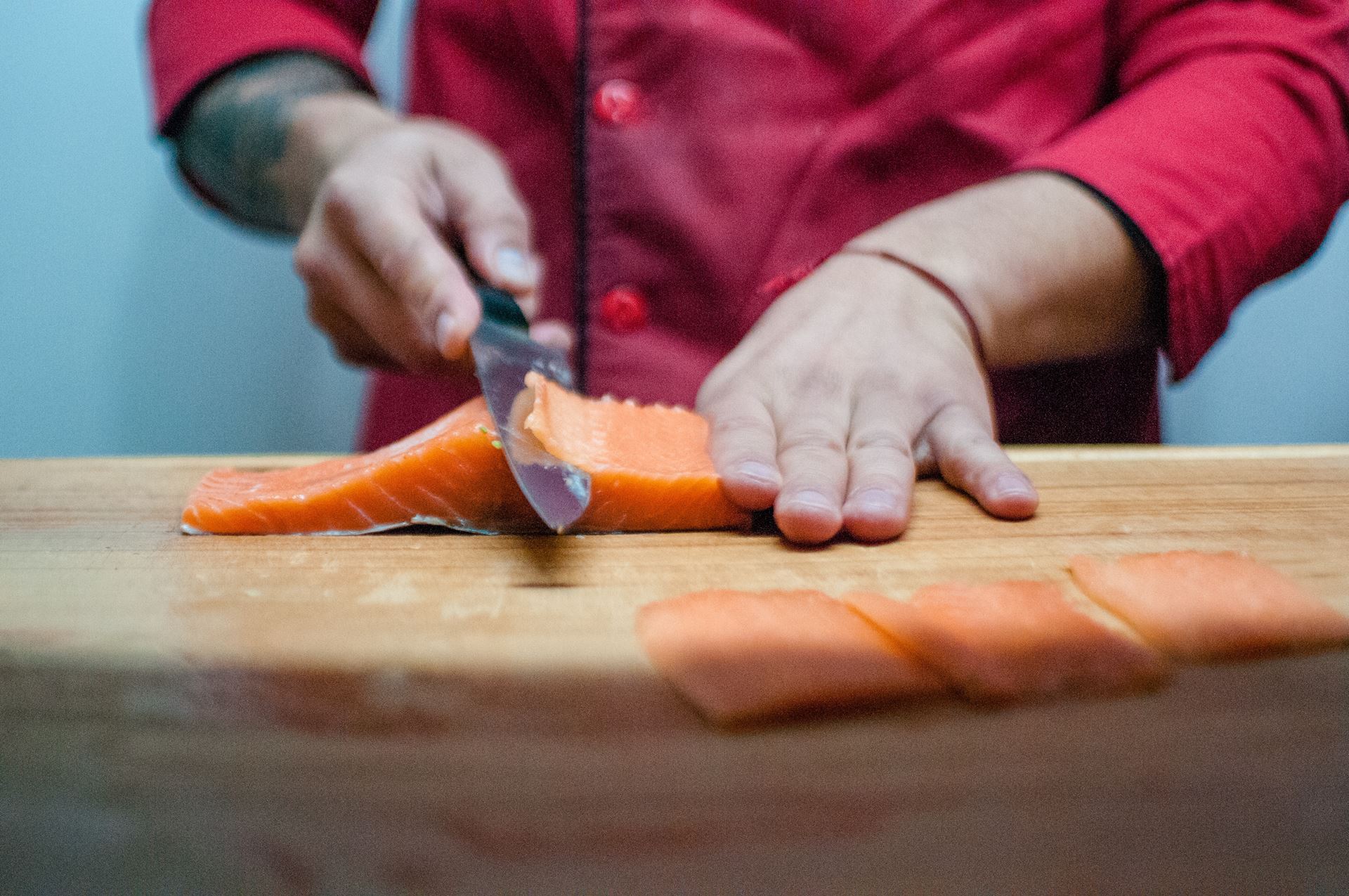 a person sitting on a cutting board